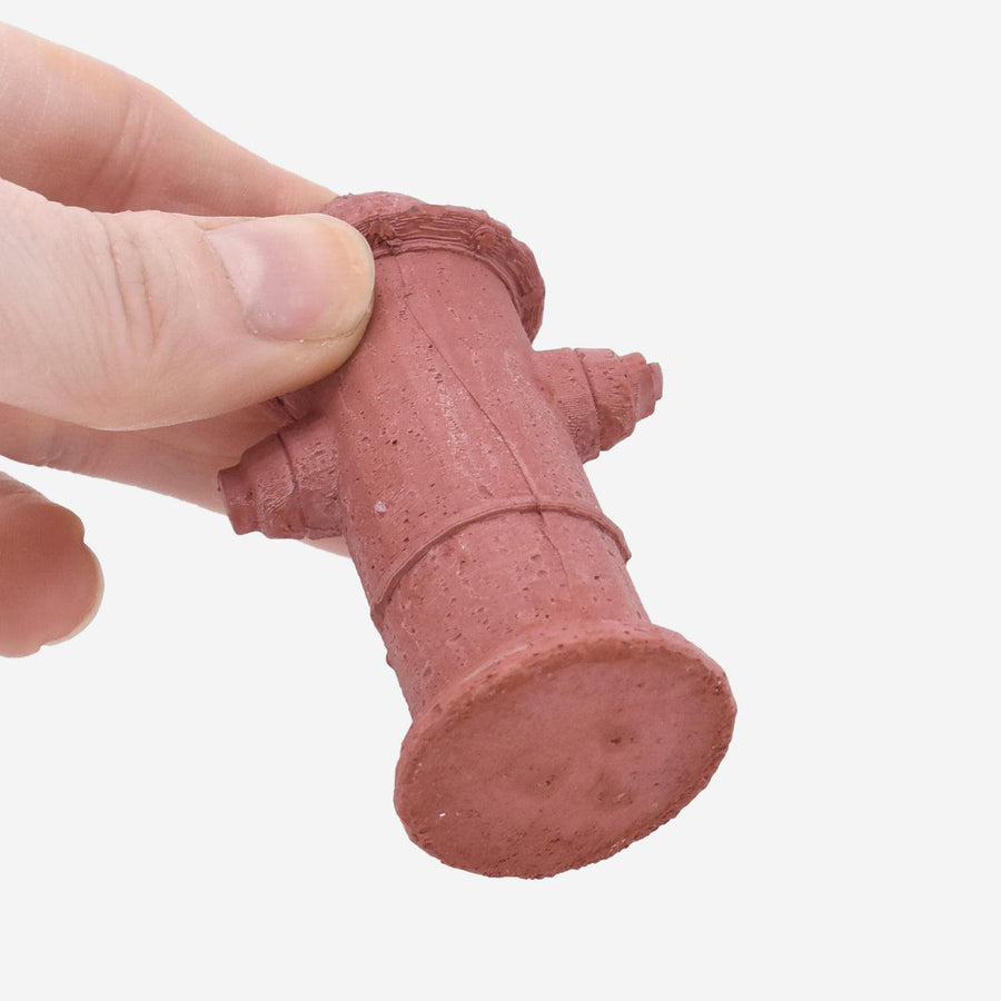 1:12 scale miniature red-dyed concrete fire hydrant being held by a hand to show scale.
